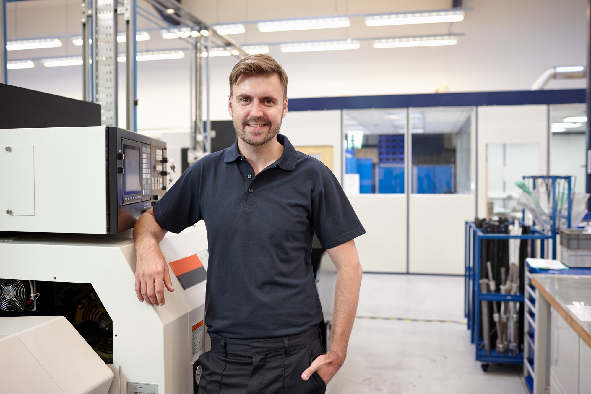 Portrait of engineer and equipment in engineering factory